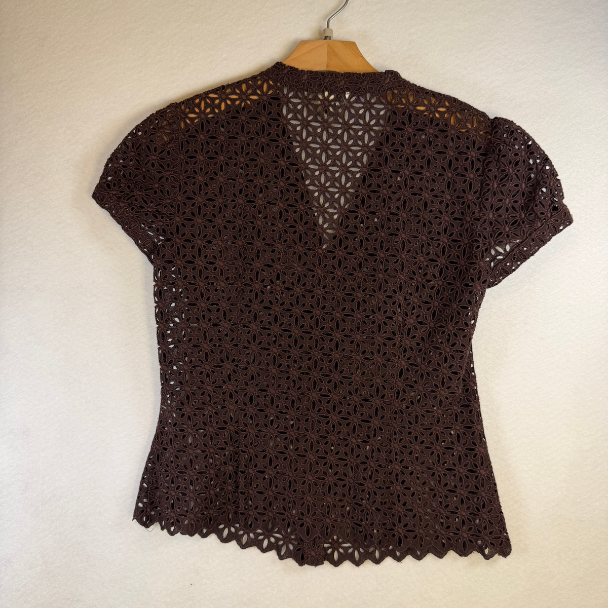Back of brown Milly eyelet blouse with scalloped hem
