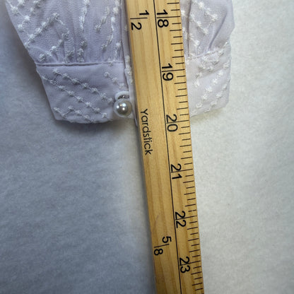 Oleada Top retail tag showing white size Medium and $99.95