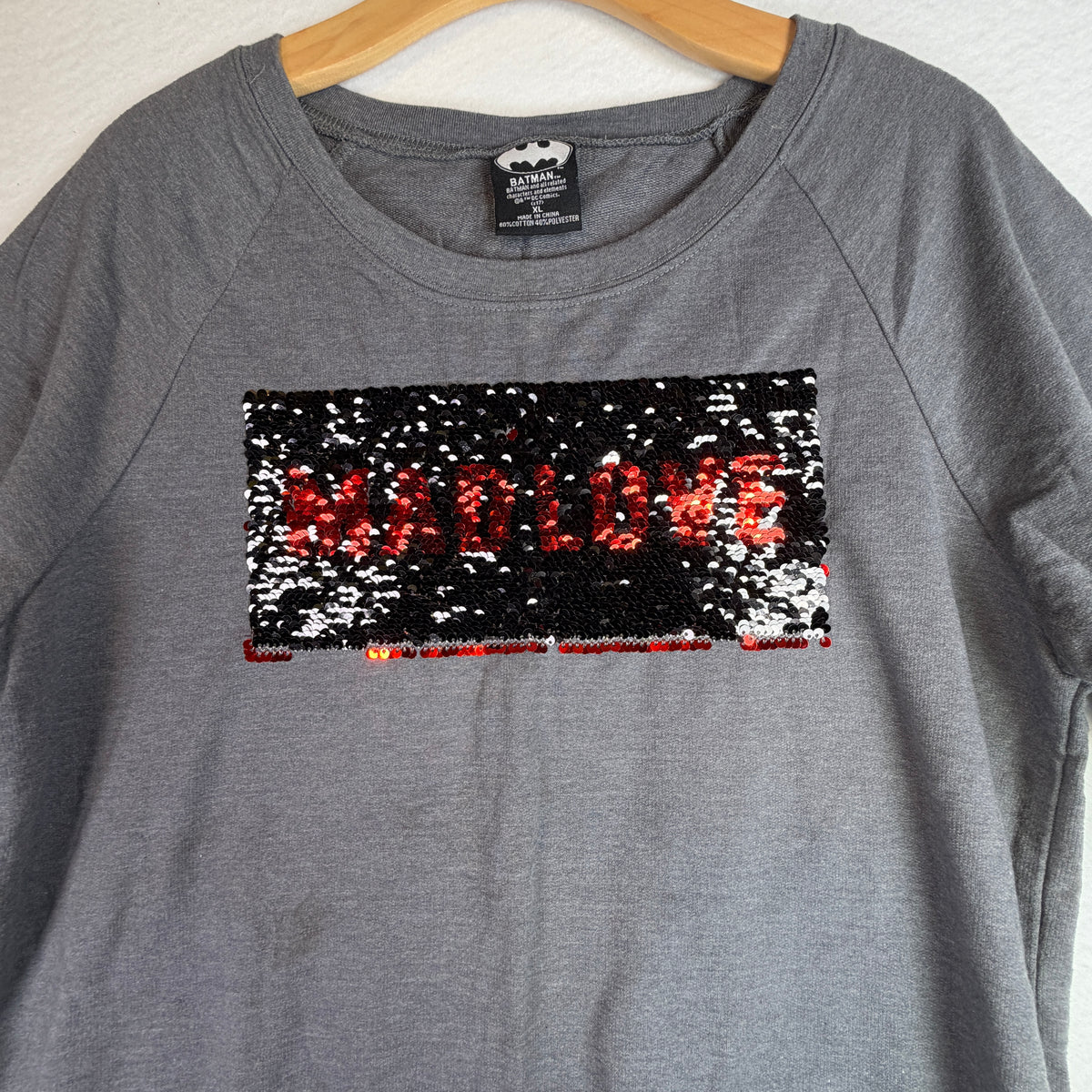 Close-up of red reversible sequins with black diamond pattern.
