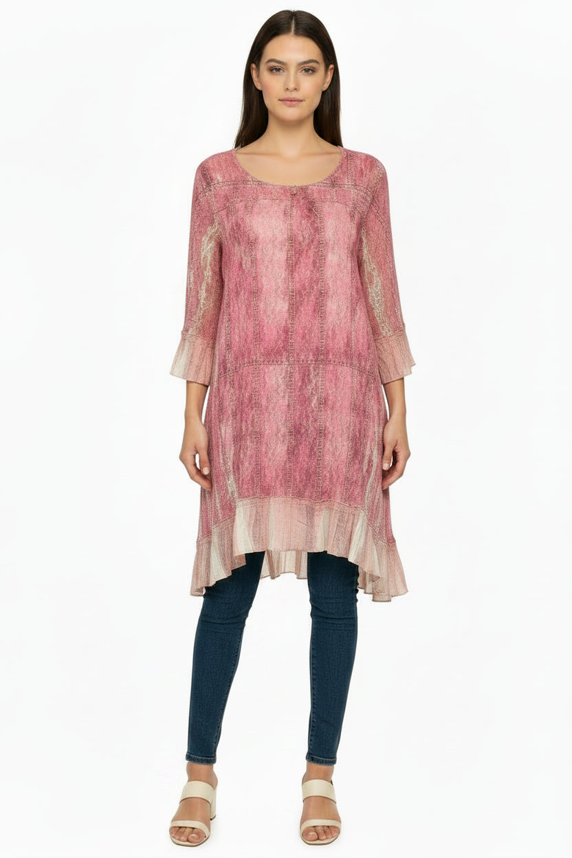 Pink patterned tunic top on a mannequin against a white background