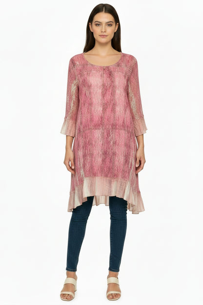 Pink patterned tunic top on a mannequin against a white background