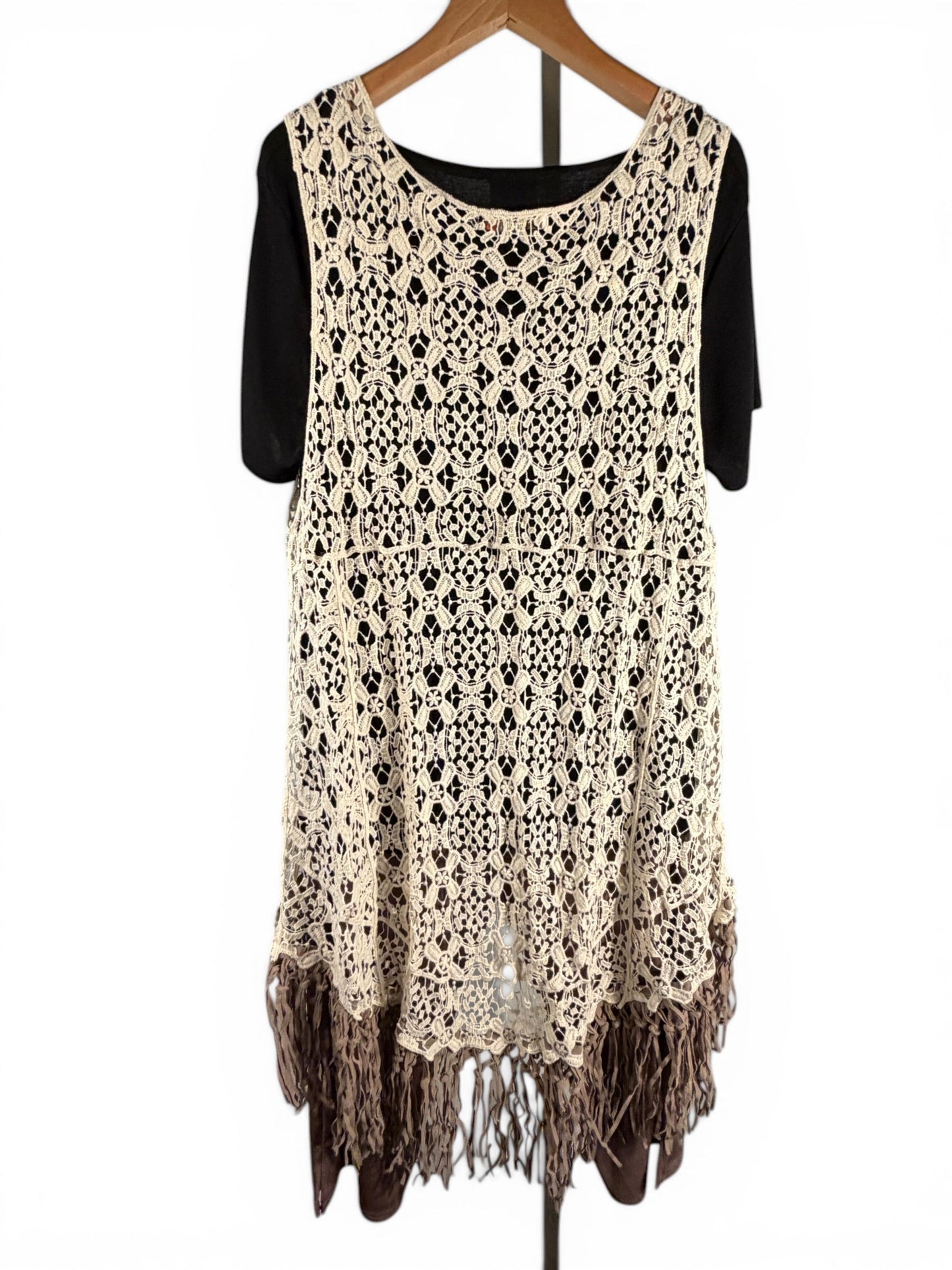 Leah Litty Lew The Boutique ivory crochet lace vest with fringe trim and open front design on a hanger