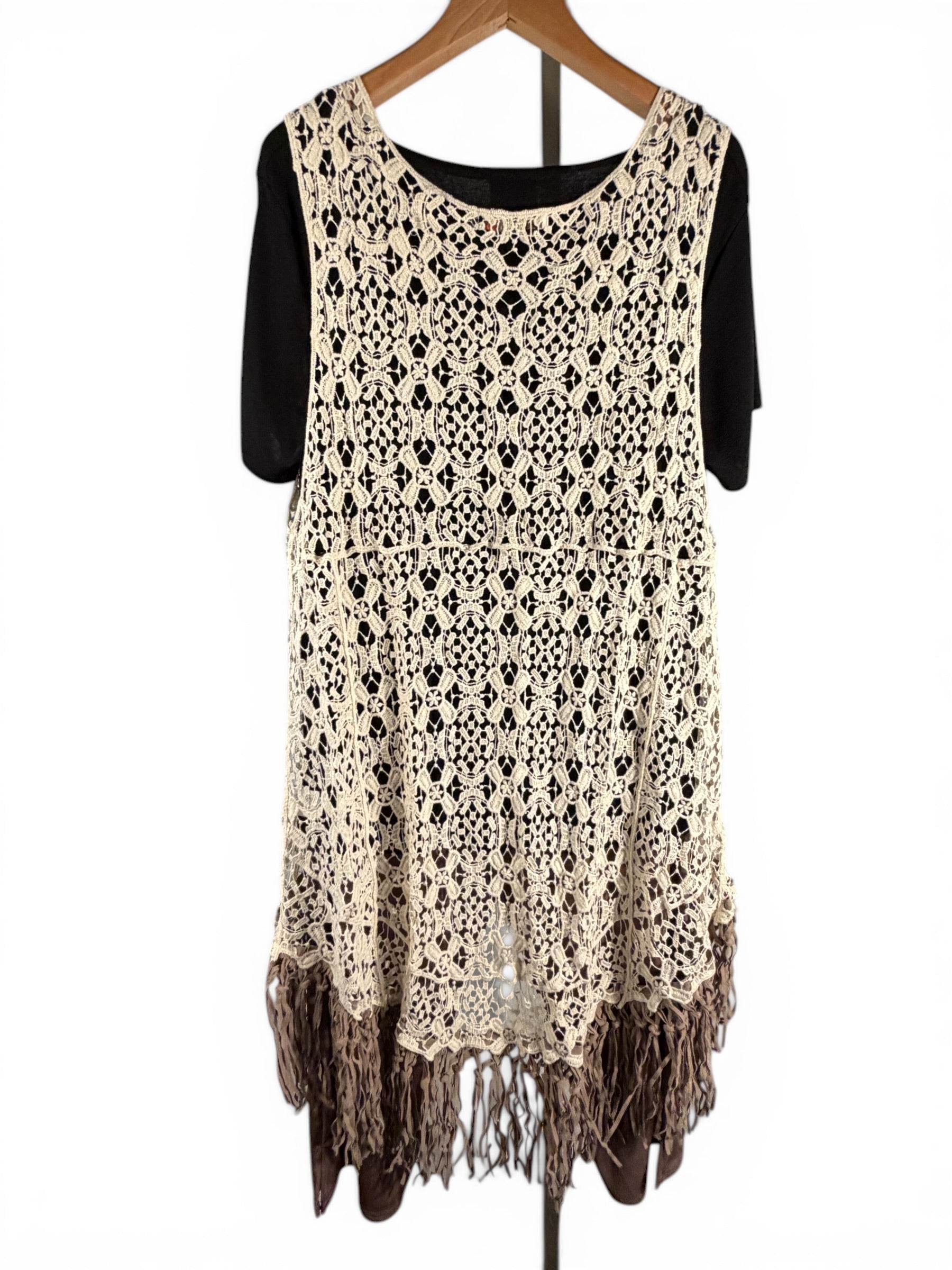Leah Litty Lew The Boutique ivory crochet lace vest with fringe trim and open front design on a hanger