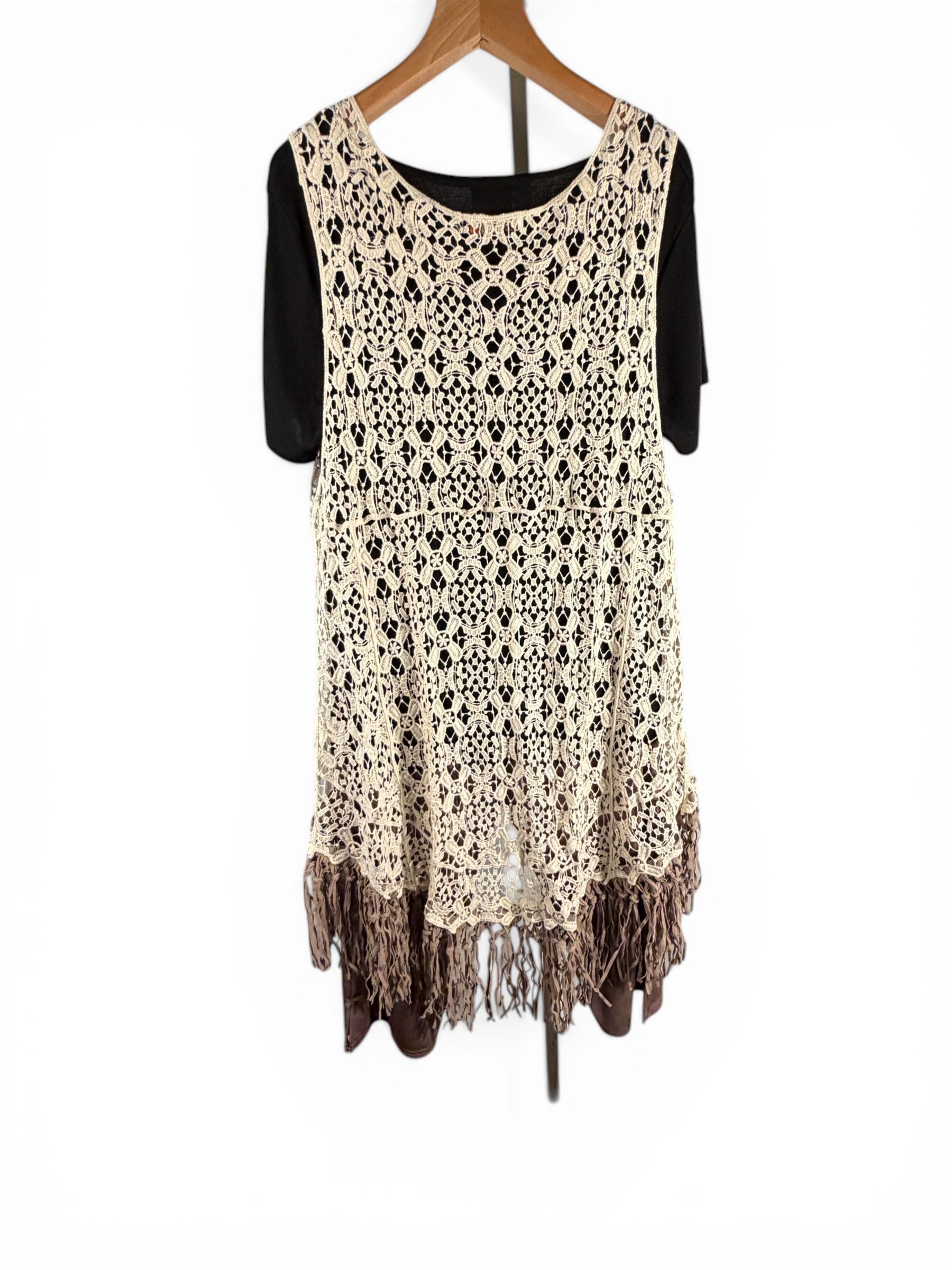 Leah Litty Lew The Boutique ivory crochet lace vest with fringe trim and open front design on a hanger